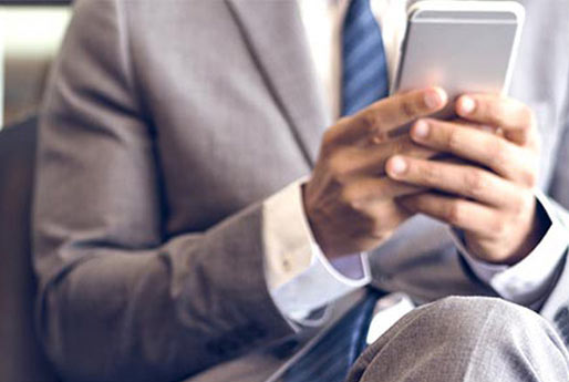 Man in a suit banking on his smart phone