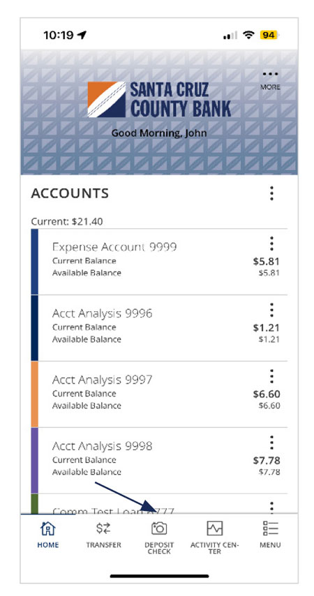 Image of the Santa Cruz County Bank mobile app’s home page after login with a list of accounts with current and available balances. A footer consists of: Home, Transfer, Deposit Check, Activity Center and Menu. Deposit Check is noted.